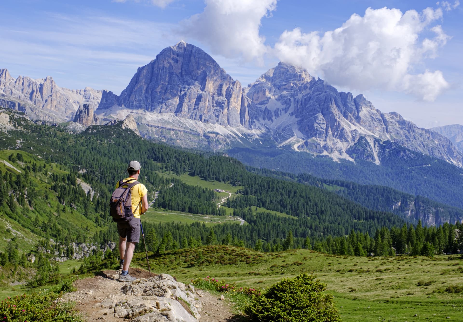 The hiker, after conquering the Giau Pass, enjoyed the majestic Cinque Torri while planning the next stage of his adventure on the challenging Alta Via 1, Italy.