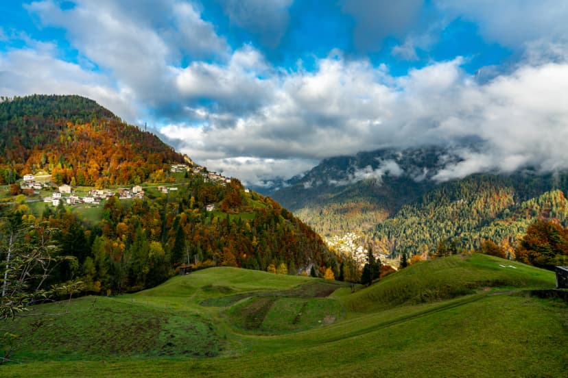 Colourful aumtumn picture across the Cordevole valley with Pecol and Piaia villages in the background