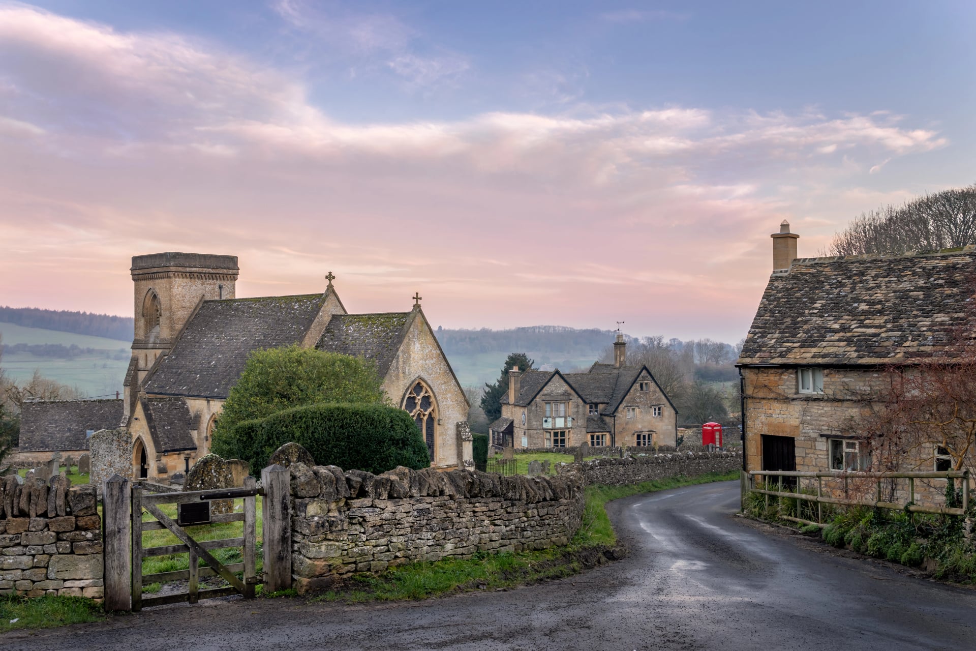 Snowshill village church and red telephone box on a Cotswold lane