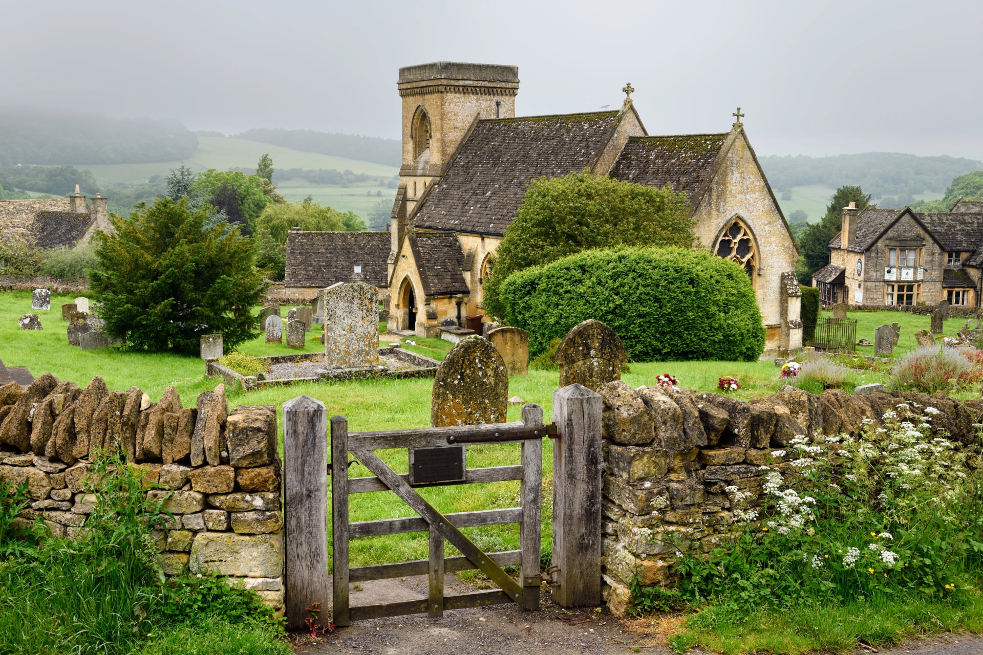 Wooden gate in a drystone wall at Snowshill churchyard