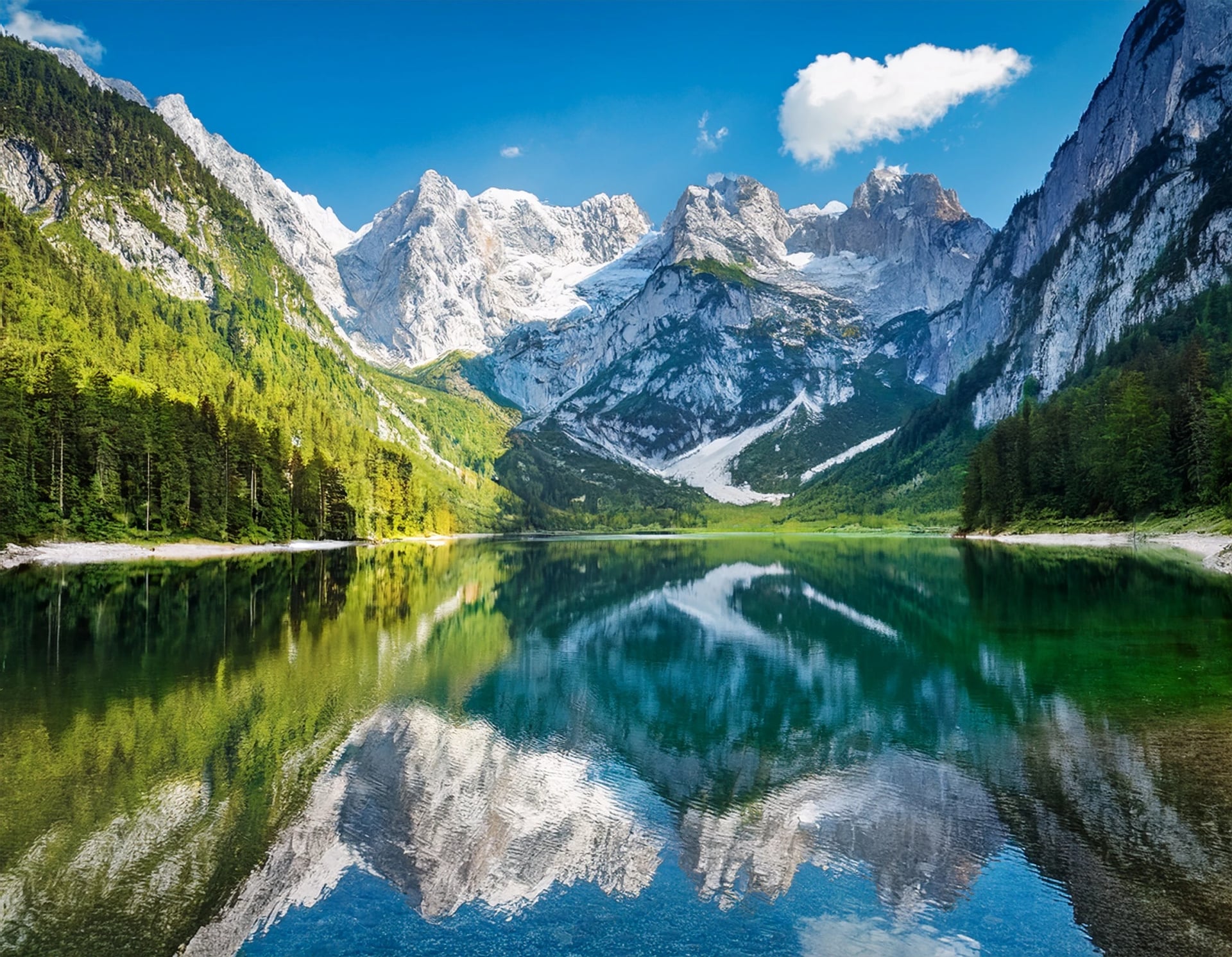 The Dachstein glacier reflected in the still water of the Gosausee