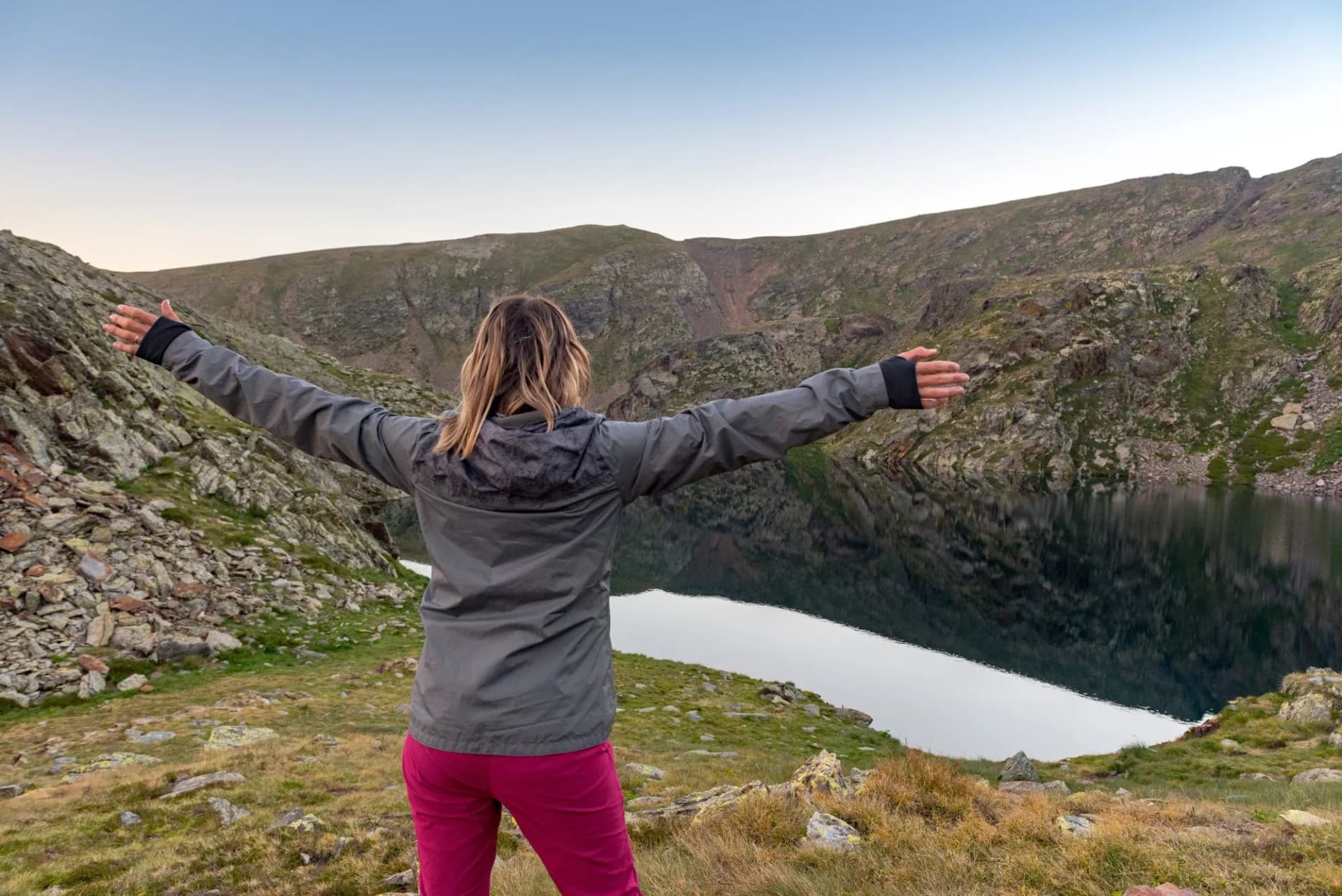 Woman in the Vall de Riu lake from the Estanyo peak in Andorra in summer 2020