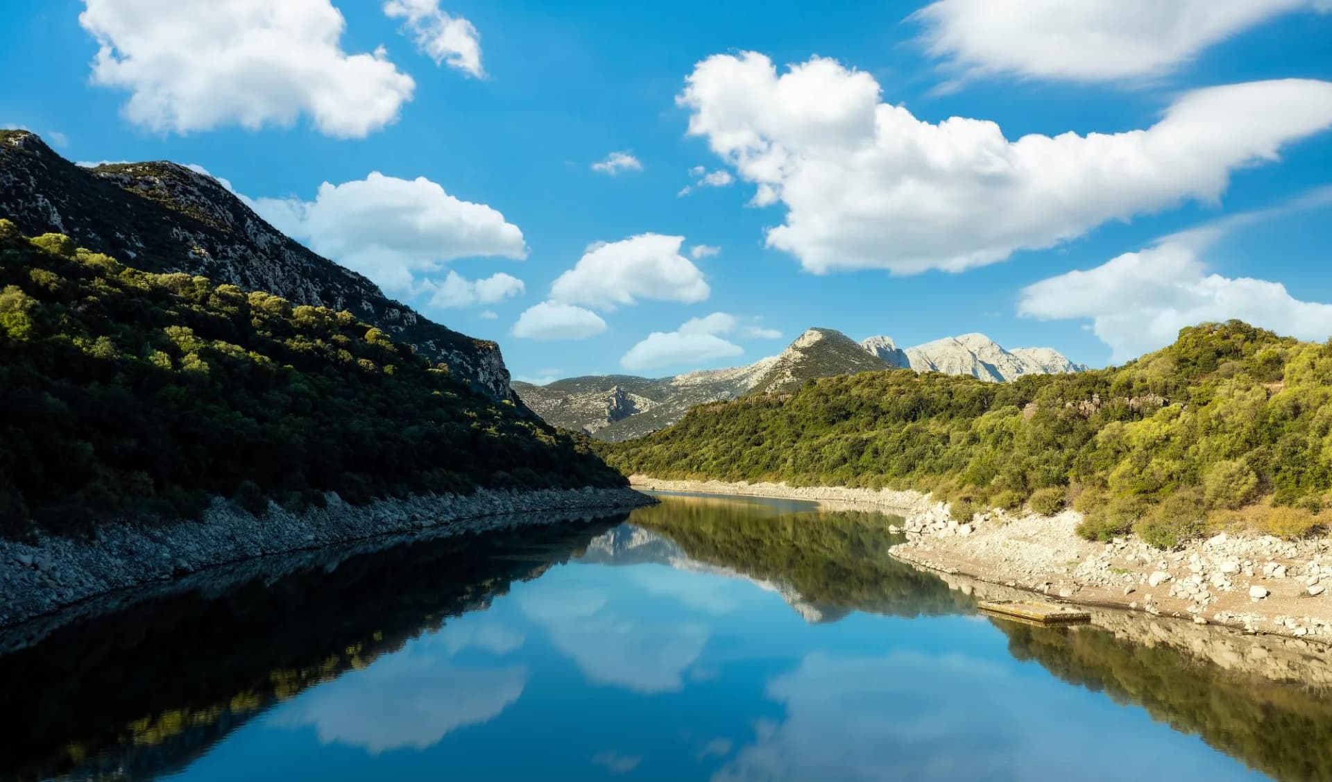 View from above, stunning aerial view of the Cedrino Lake - Lago del Cedrino surrounded by the mountain range of Supramonte located northeast of the Gennargentu massif. Sardinia, Italy.