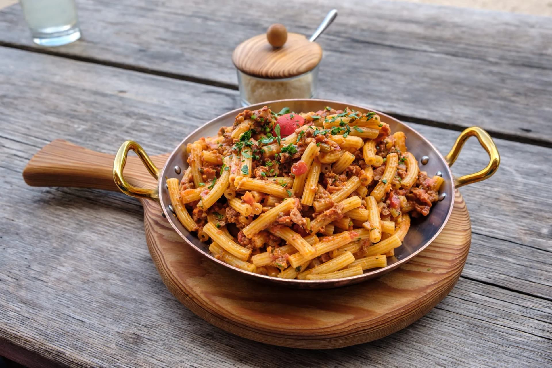 Old pan with shepherd-style macaroni on the terrace of an Italian mountain hut in South Tyrol.