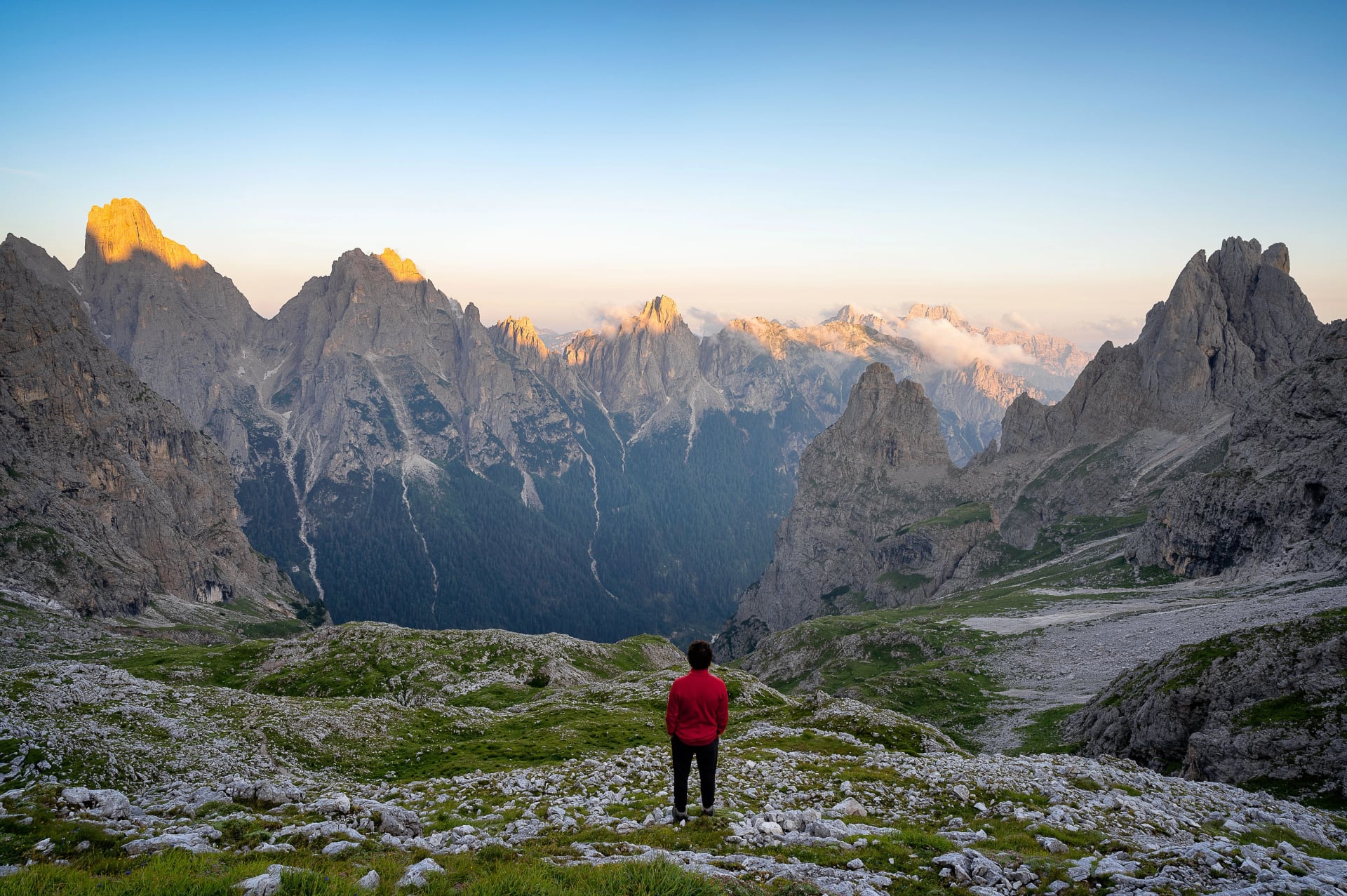 Aerial view of a hiker looking at the view from the Pale di San Martino in the Italian Alps