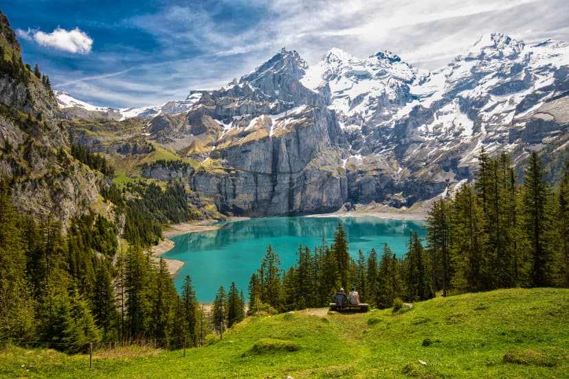 Amazing tourquise Oeschinnensee with waterfalls, wooden chalet and Swiss Alps, Berner Oberland, Switzerland.