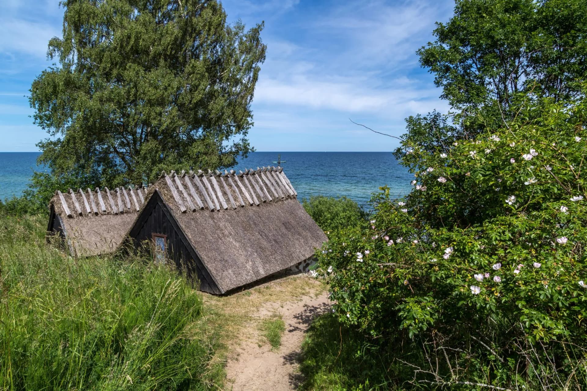 View of Knäbäckshusens Chapel on a sunny summer day with the blue waters of the Baltic Sea in the background.