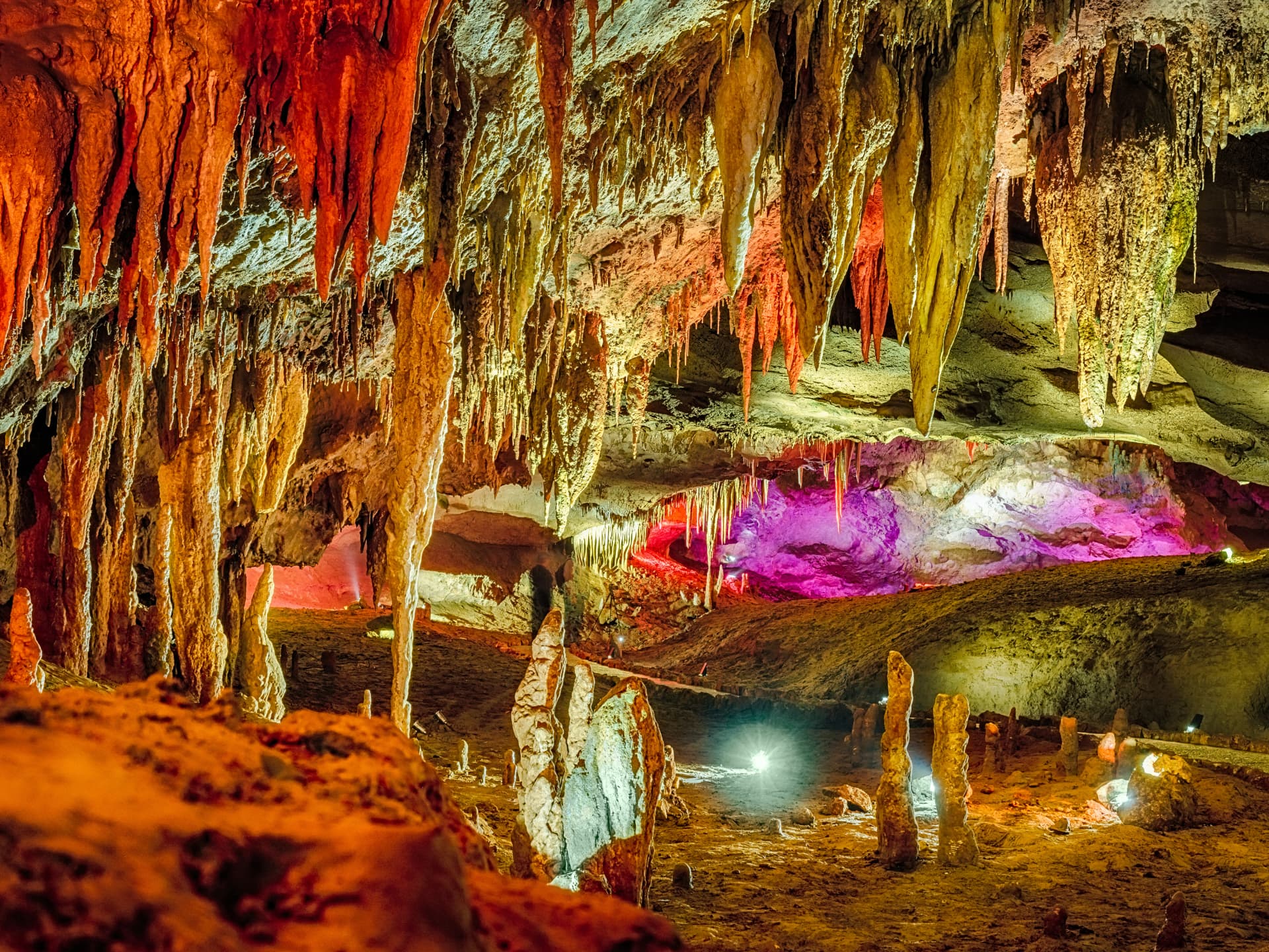 Wonderful Prometheus Cave. Stalactites and stalagmites in the illuminated cave