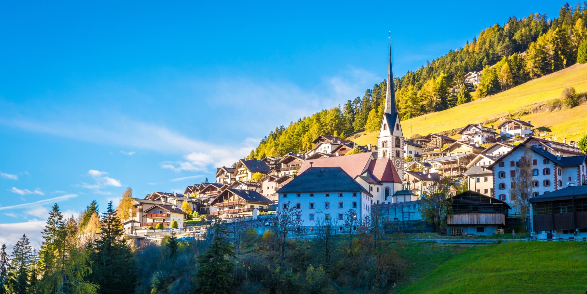autumn landscape in Gardena Valley. The town of Santa Cristina (St. Christina in Groden) with the light of the sunset, located in the heart of Dolomites, a Unesco World Heritage, South Tyrol, Italy