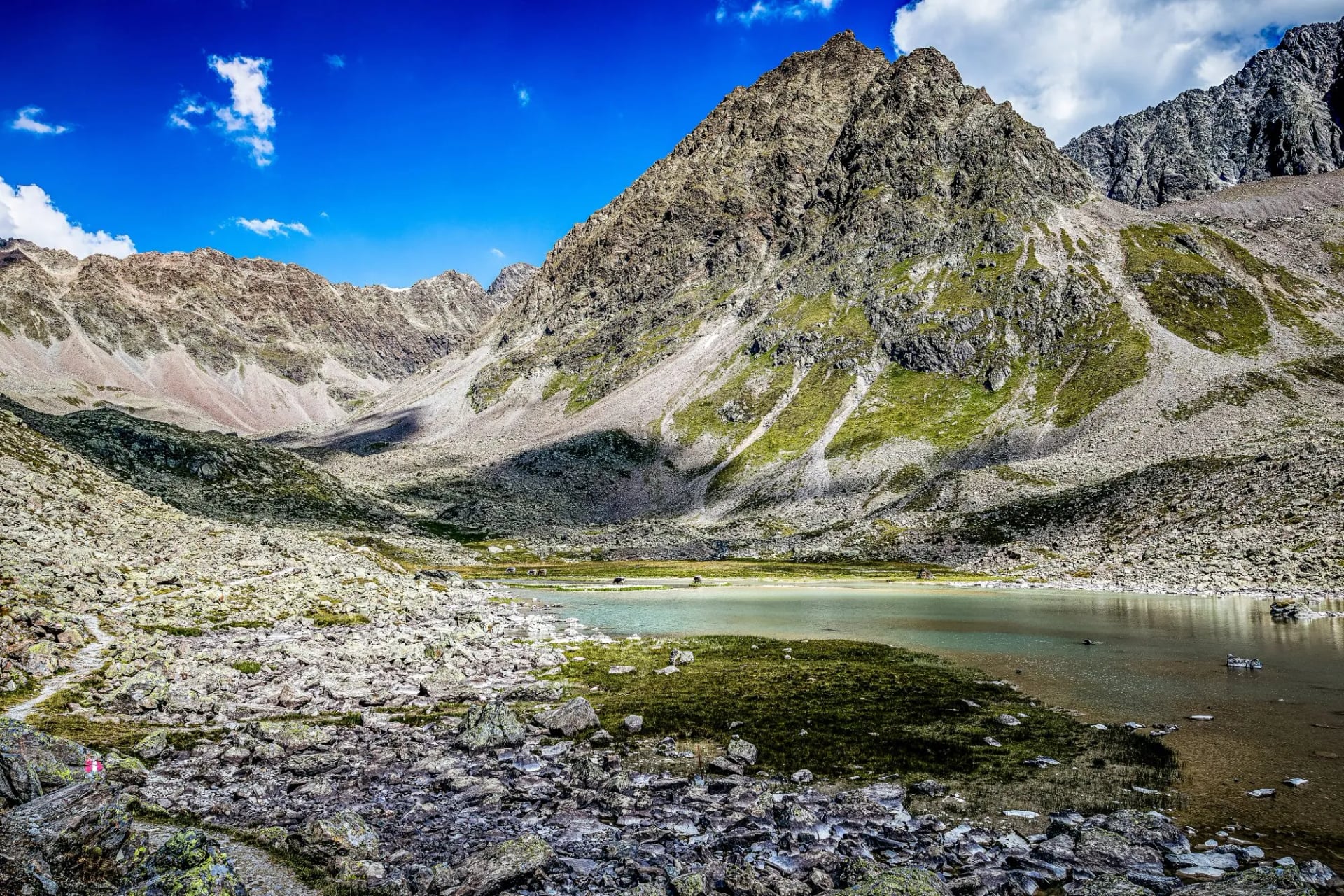 A turquoise tarn in a rocky cirque near the Winnebachsee