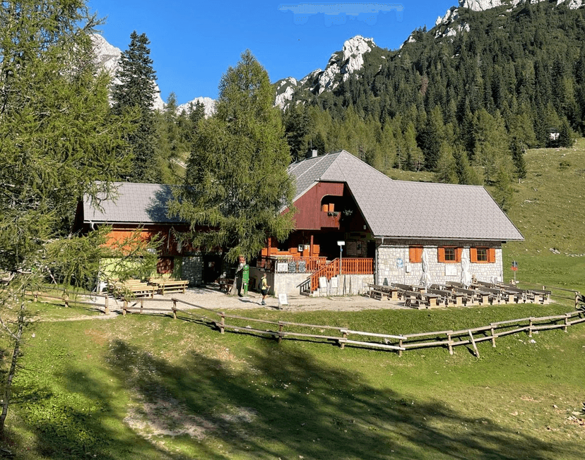 Mountain hut with outdoor seating at Zelenica in the Karawanks range.