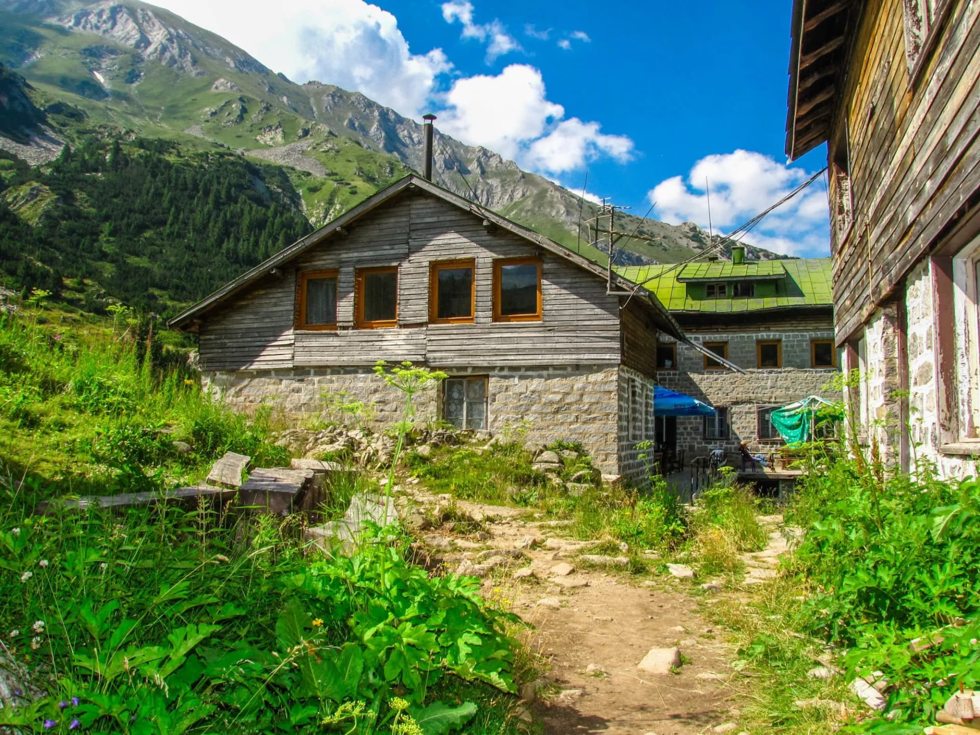 Vihren chalet small building in the background is the peak Vihren Pirin Mountain. Bulgaria