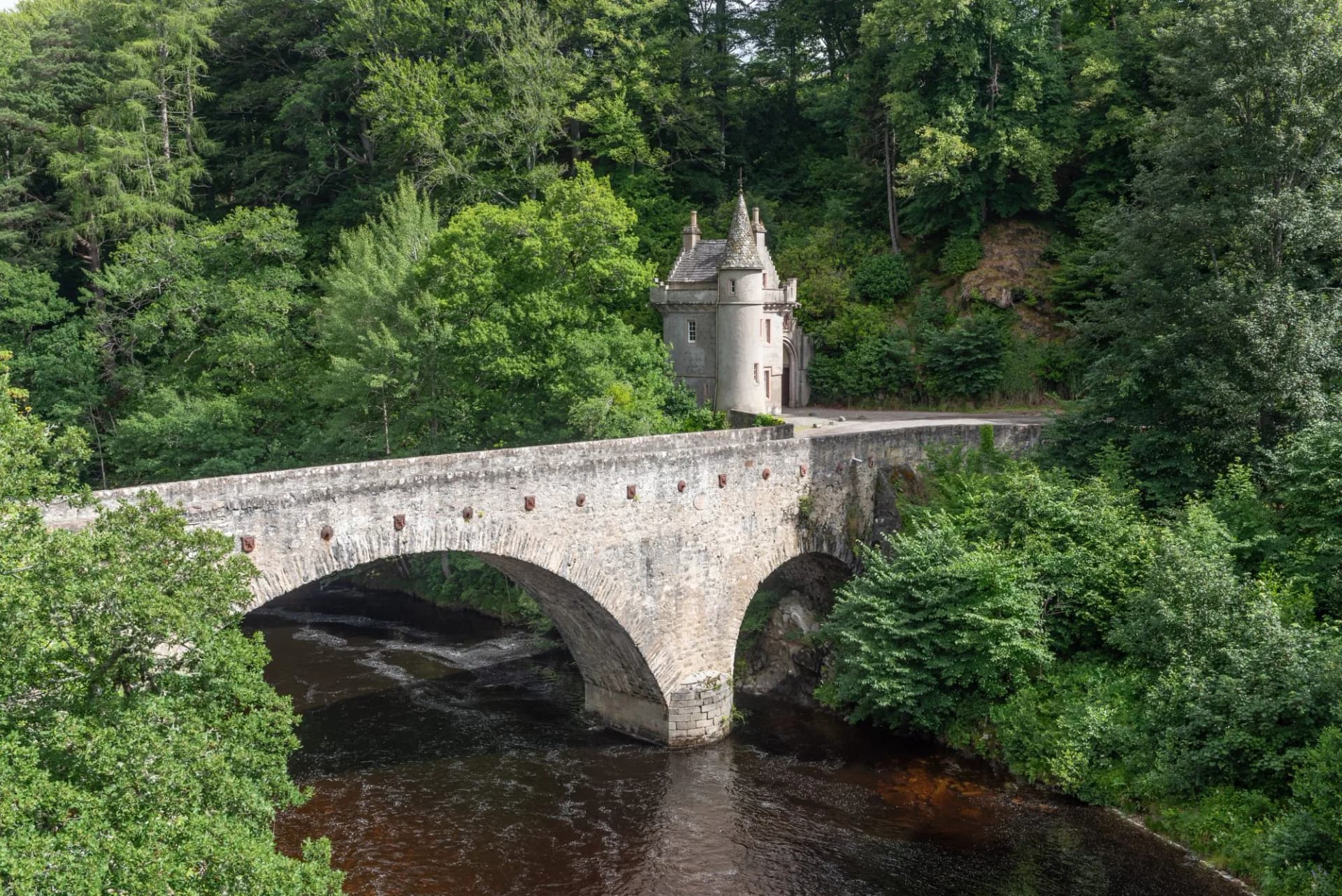 The stone Bridge of Avon over the Avon river with its picturesque gatehouse. Near Ballindalloch, Moray, Scotland, United Kingdom, and built between 1800