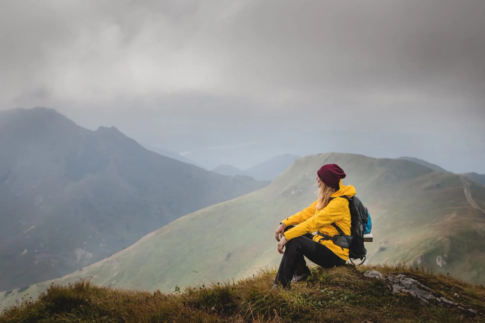 Relaxation at mountain peak know as Velky Krivan. Woman tourist enjoying view after succesfully hike at Mala Fatra, Slovakia