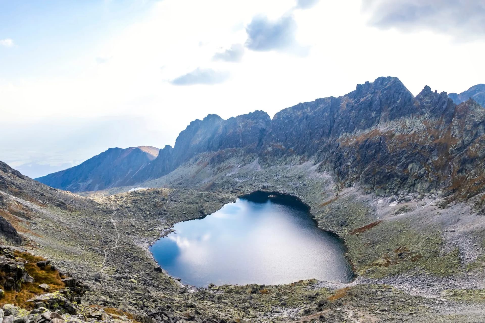 Hiking in High Tatras Mountains, Slovakia. Vysne Wahlenbergovo Pleso Lake (2154m) in Furkotska valley. Is the second highest situated lake in the Tatras. Mount Ostra (2351m) on the background.
