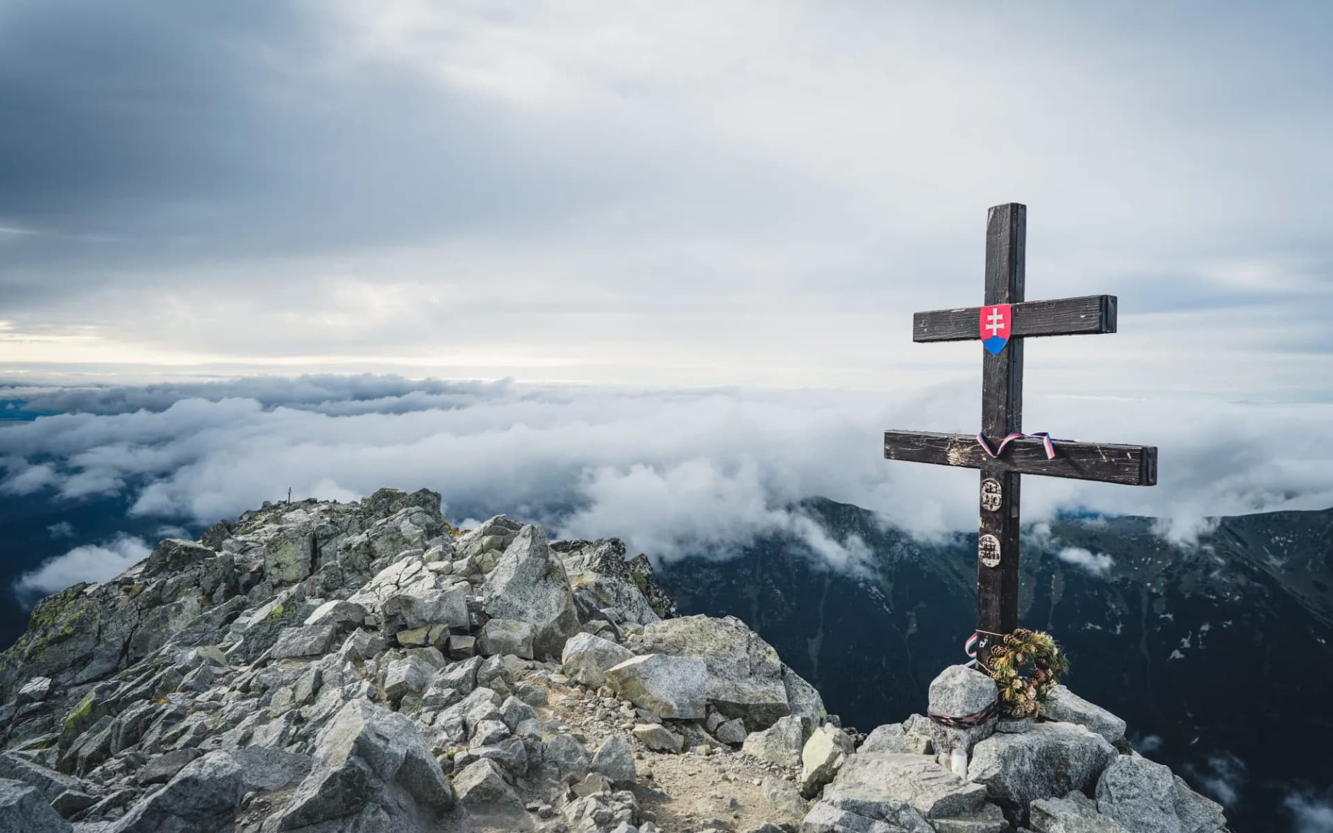 Panoramic landscape view of mountains from Krivan peak, High Tatras, Slovakia, Europe. Slovak double cross in Krivan peak. Travel destination. Hiking theme.