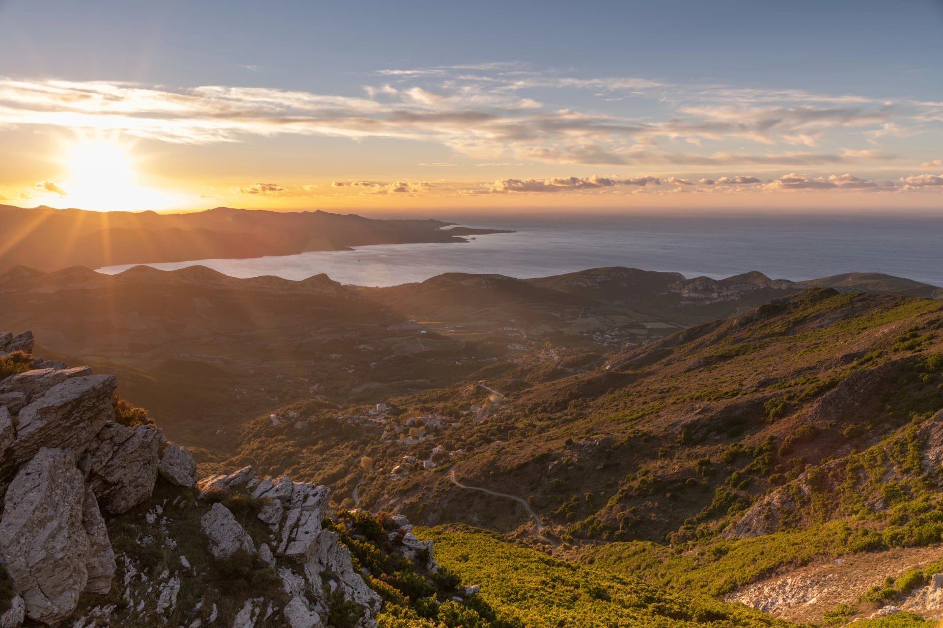 Stones and Autumn vegetation in the mountains of Corsica with the sea in the background