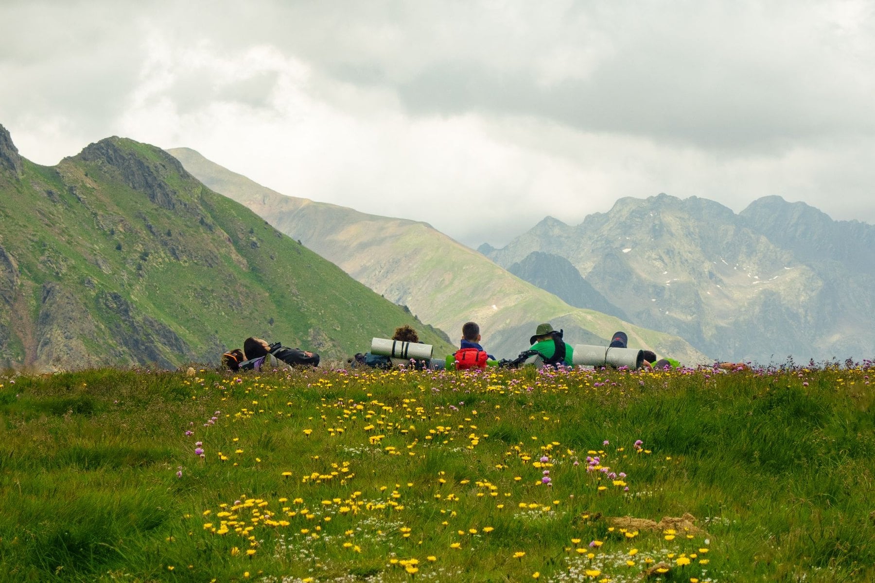 Walkers stopped for a rest on an alpine meadow