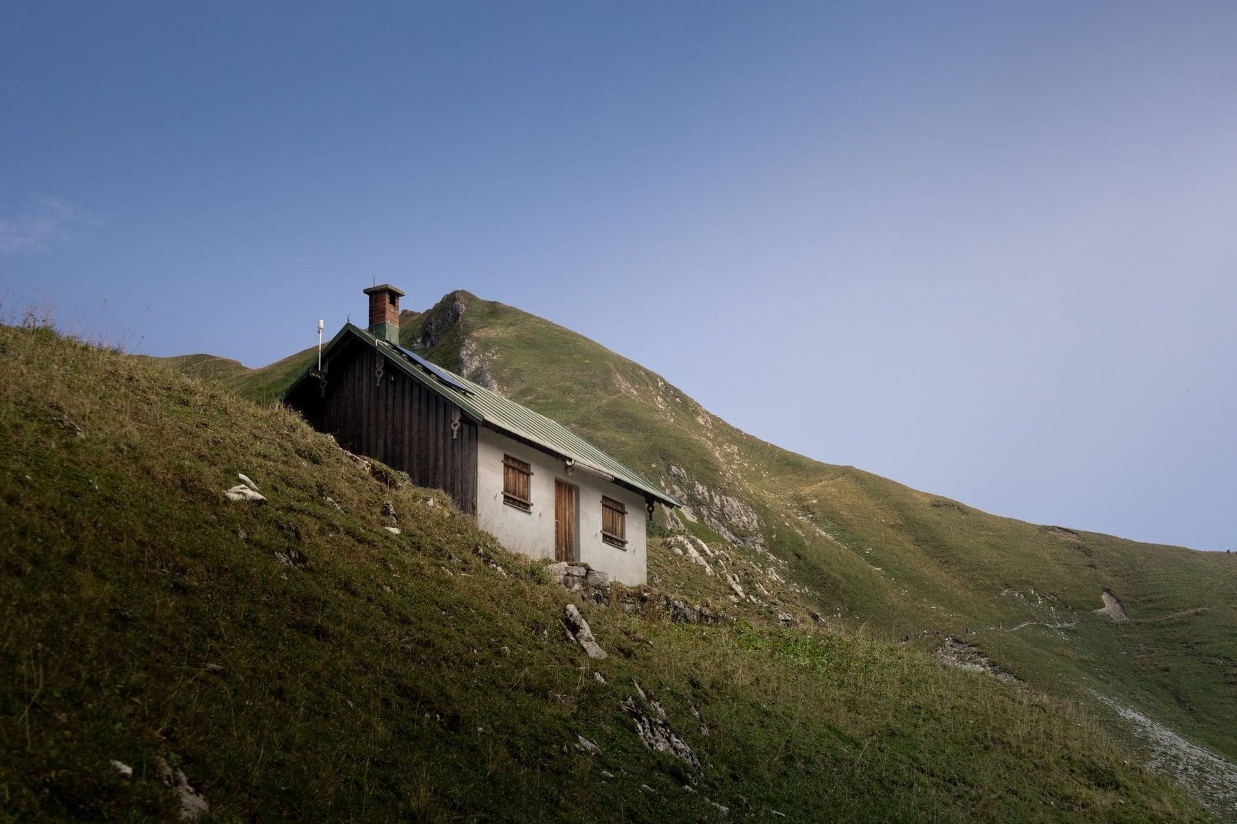A mountain hut on a grassy ridge above Bad Hindelang