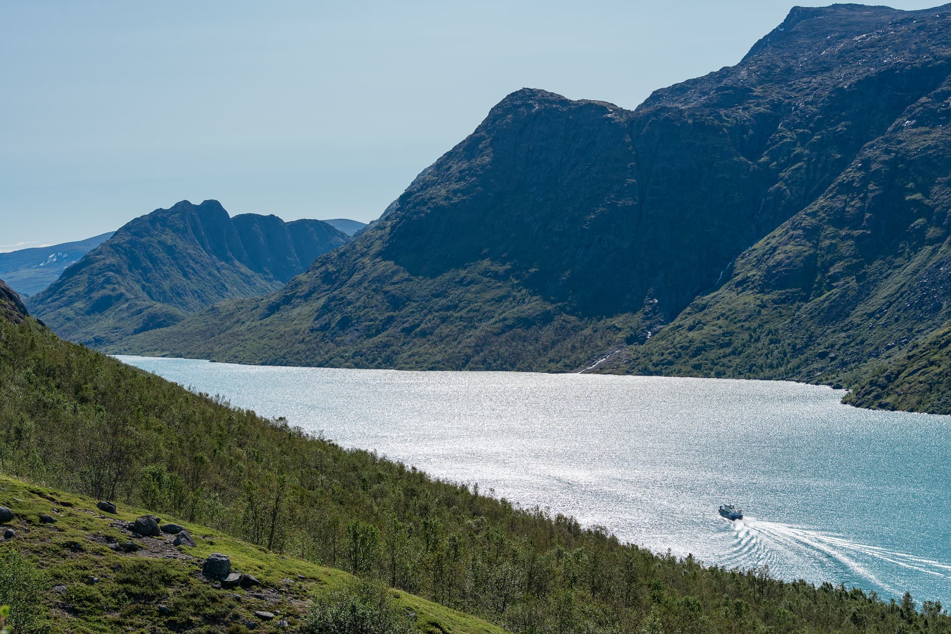 Boat on Lake Gjende surrounded by mountains in Norway