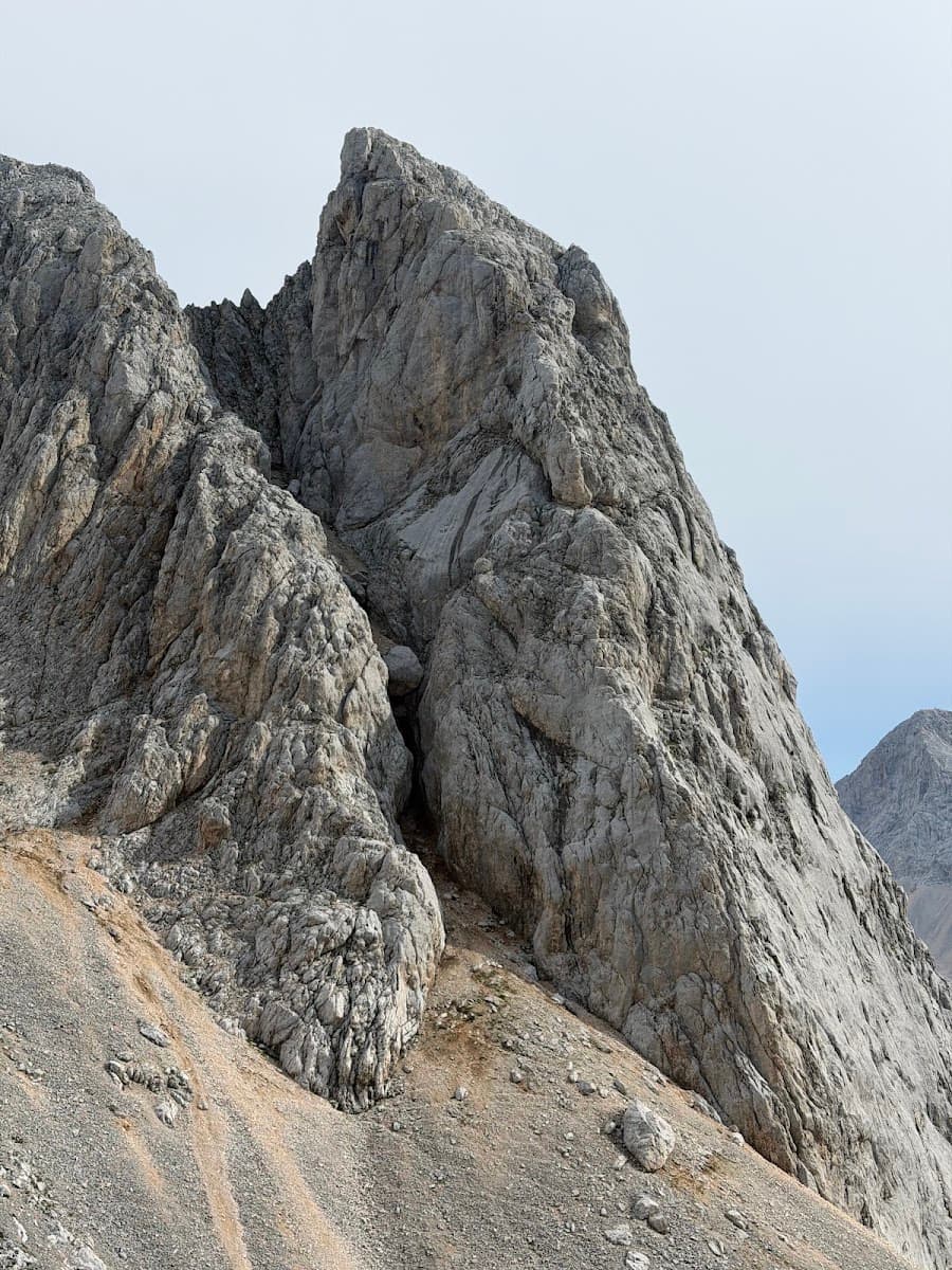 Rocky mountain peaks with jagged gray stone and loose scree slopes