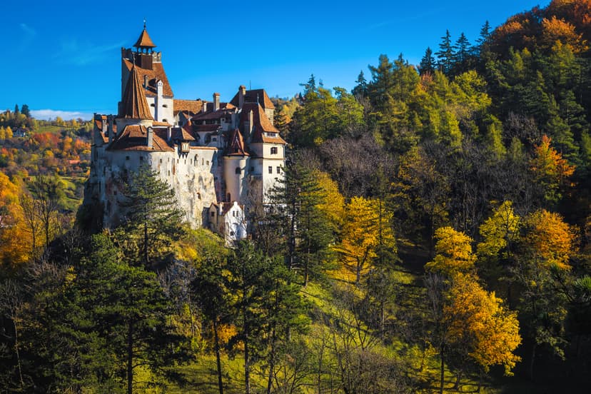 Bran Castle surrounded by autumn foliage and forests in Romania