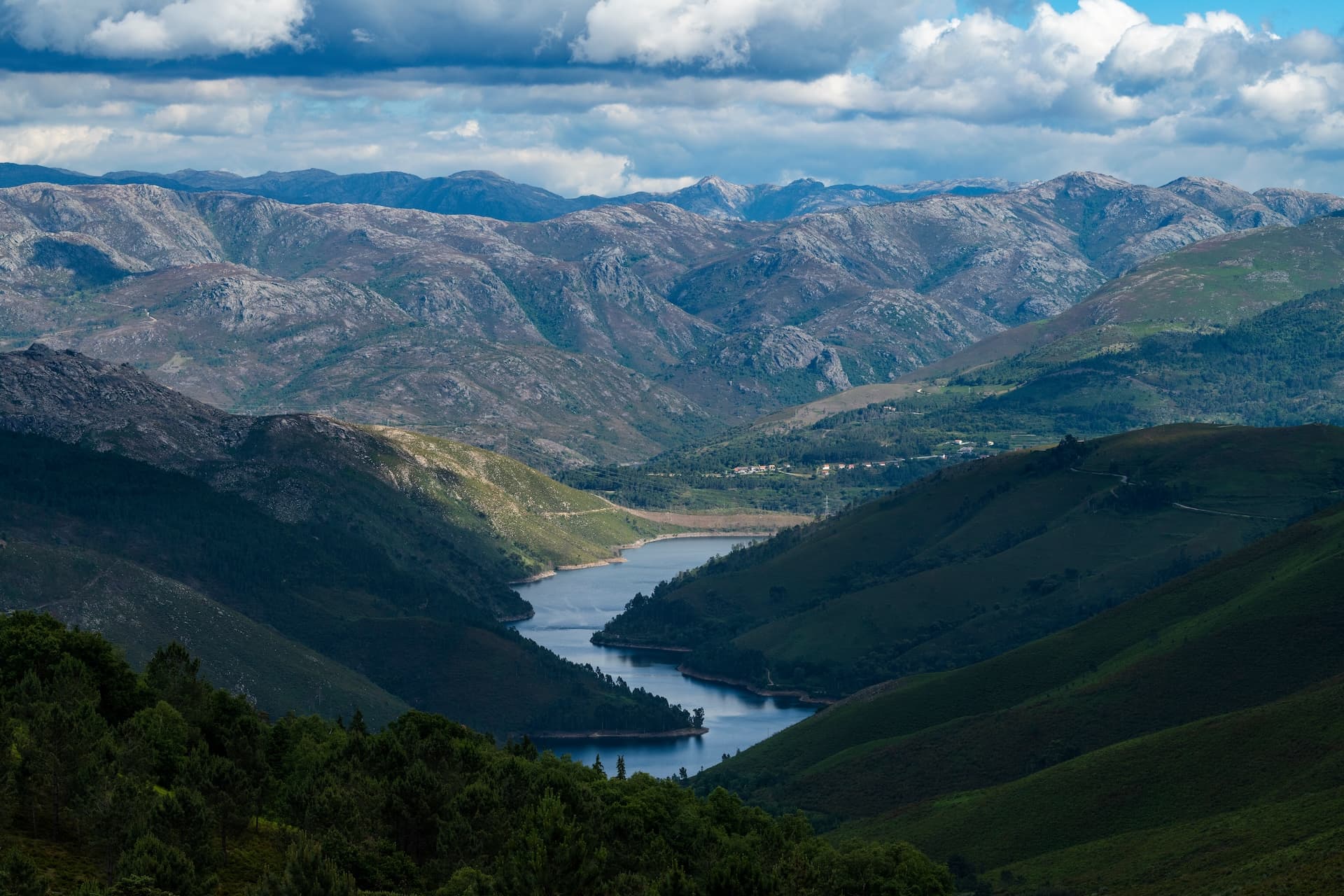 Scenic view of Alto Lindoso reservoir winding through mountains in Peneda-Geres National Park, Portugal.
