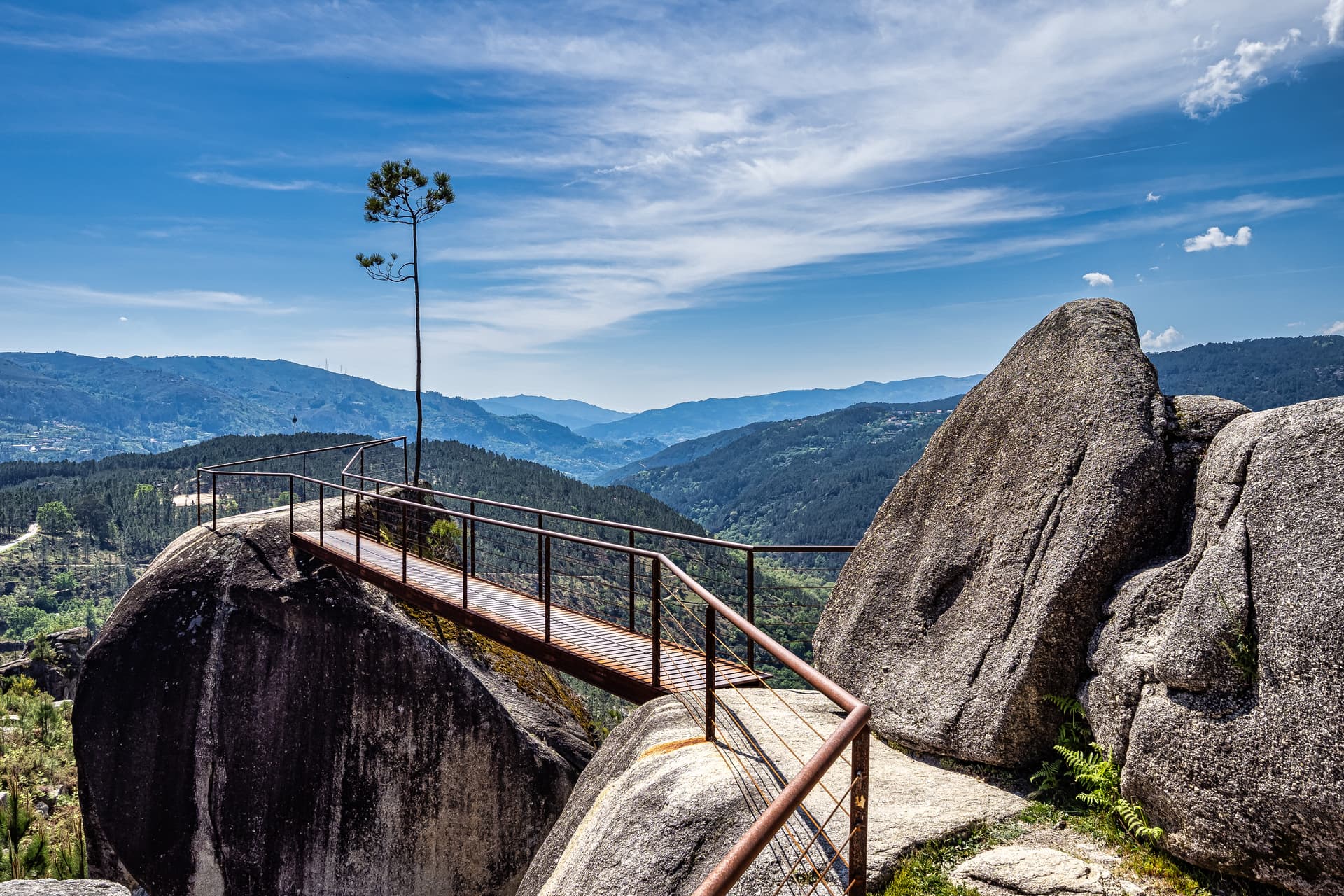 Viewpoint walkway on large boulders overlooking forested mountains near Cabril in Montalegre, Portugal.