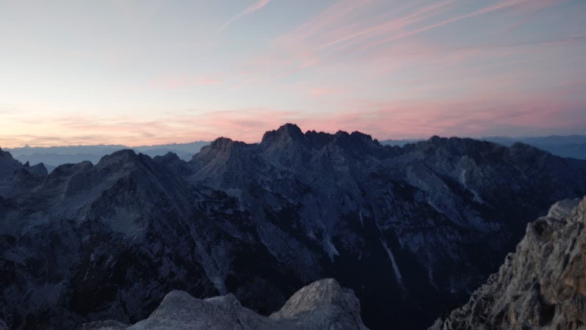 Mountain peaks under pink and blue sunset sky