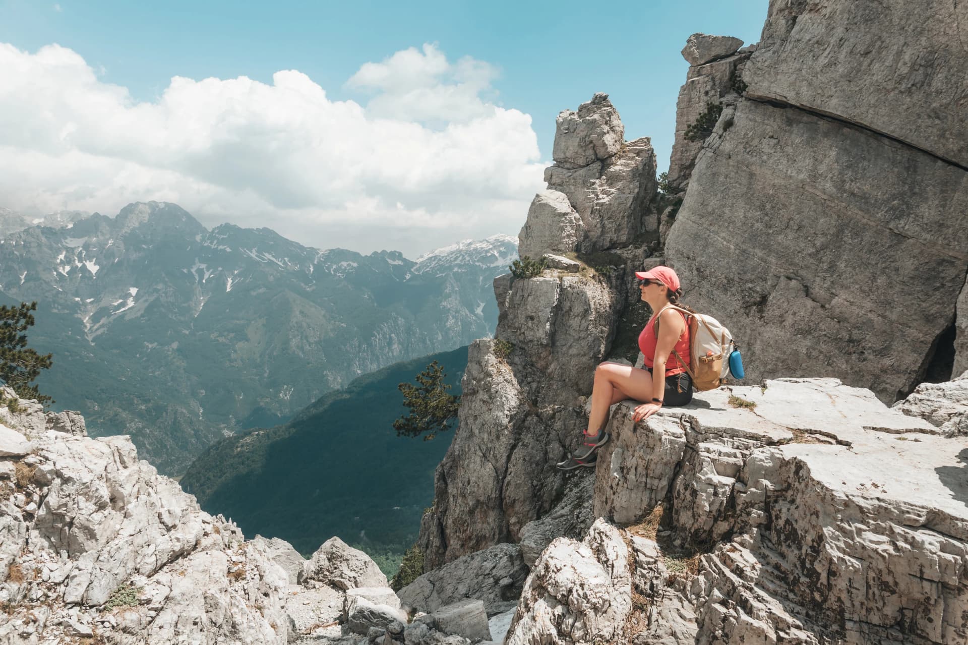 A hiker girl travels with a backpack in the Prokletie mountains. Trekking trails of Albania