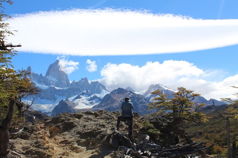 Hiker viewing Mount Fitz Roy with large lenticular cloud in Patagonia