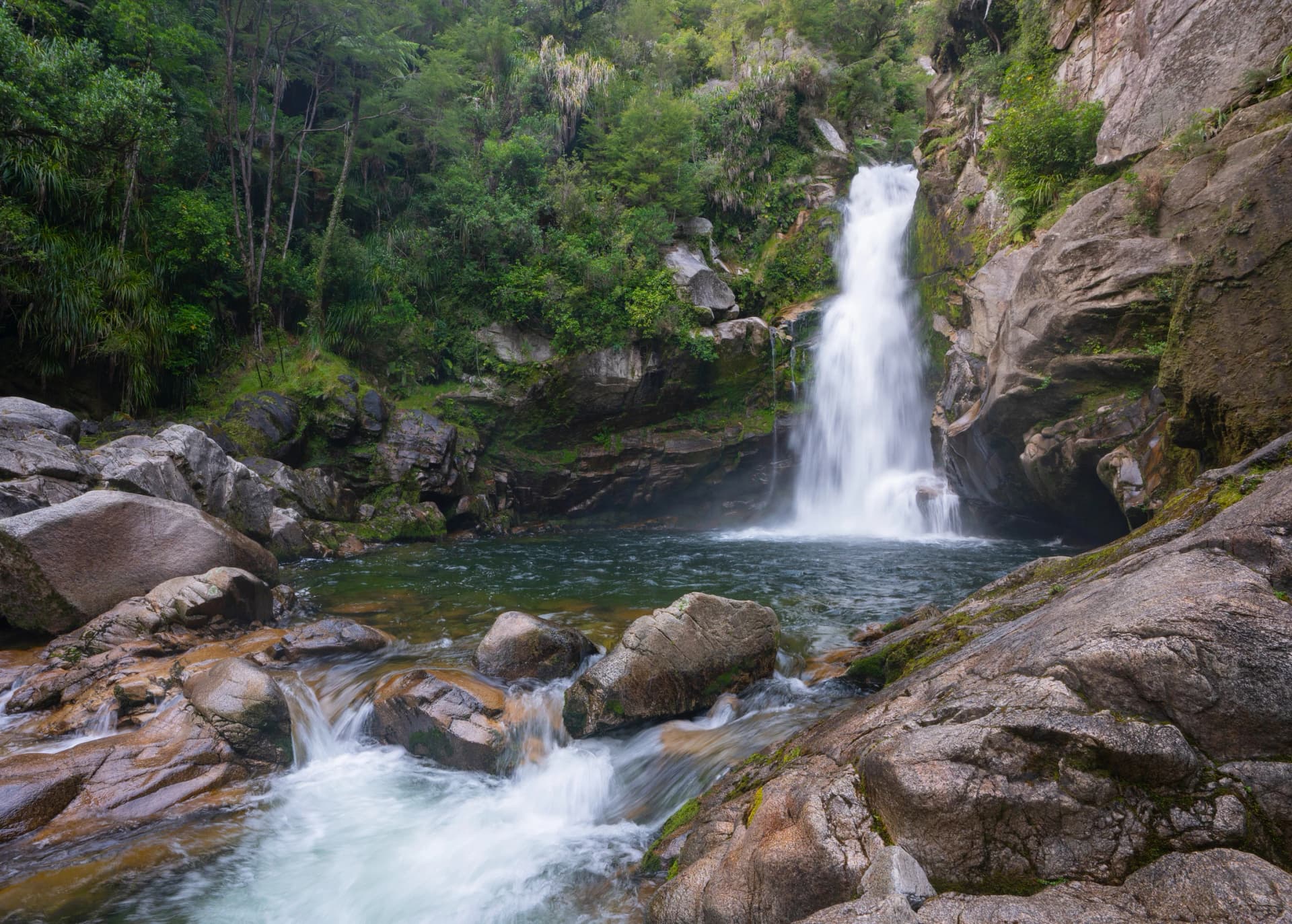 Wainui Falls is a 20-metre (66 ft) waterfall in Wainui Bay, in the Tasman region of New Zealand. The waterfall is part of the Wainui River and is a popular day walk among tourists to the region.