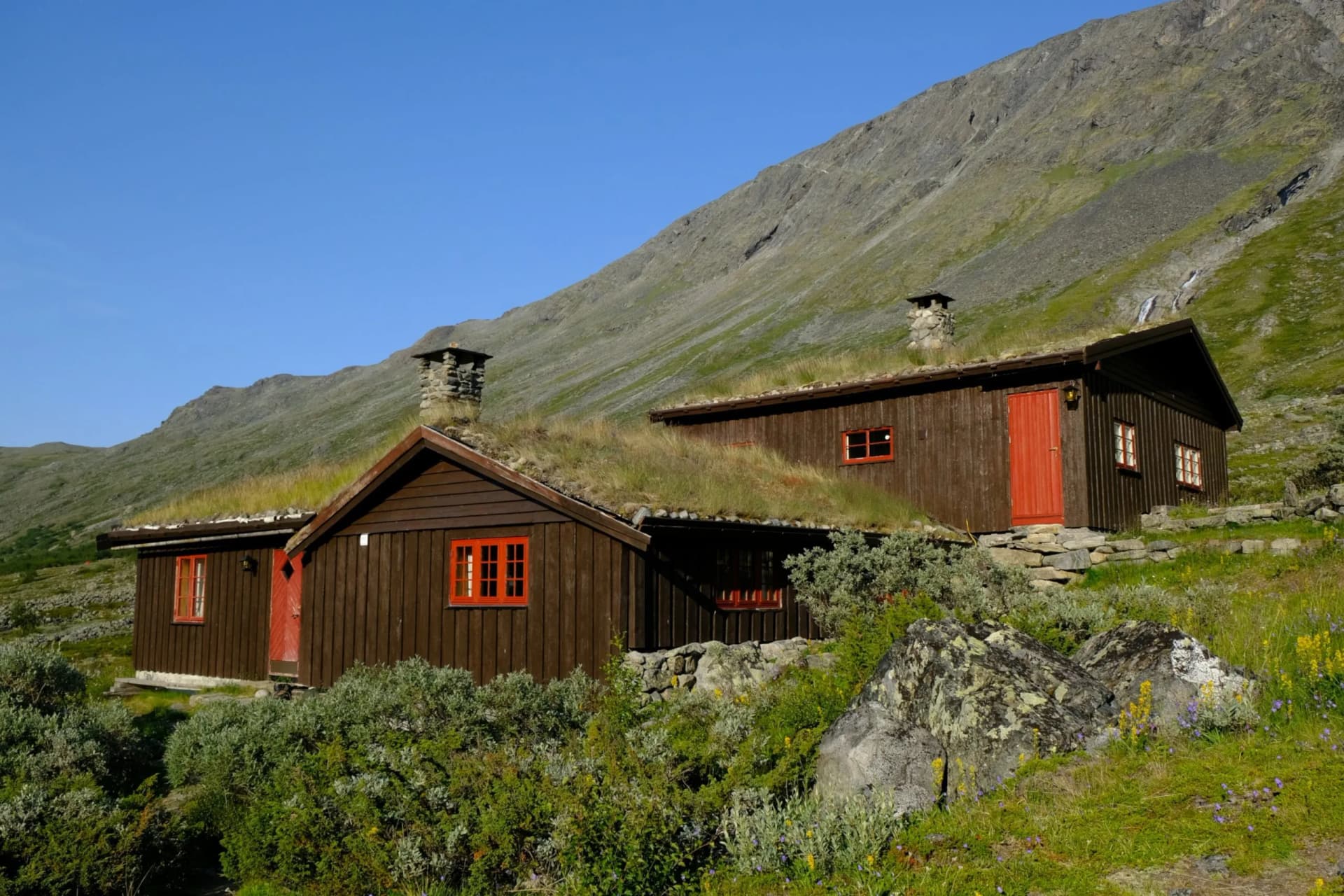 Traditional wooden turf houses in the Norwegian mountains. Spiterstulen - Norwegian tourist hostel located in Jotunheimen Mountains, in Visdalen valley, on Visa River. Jotunheimen National Park