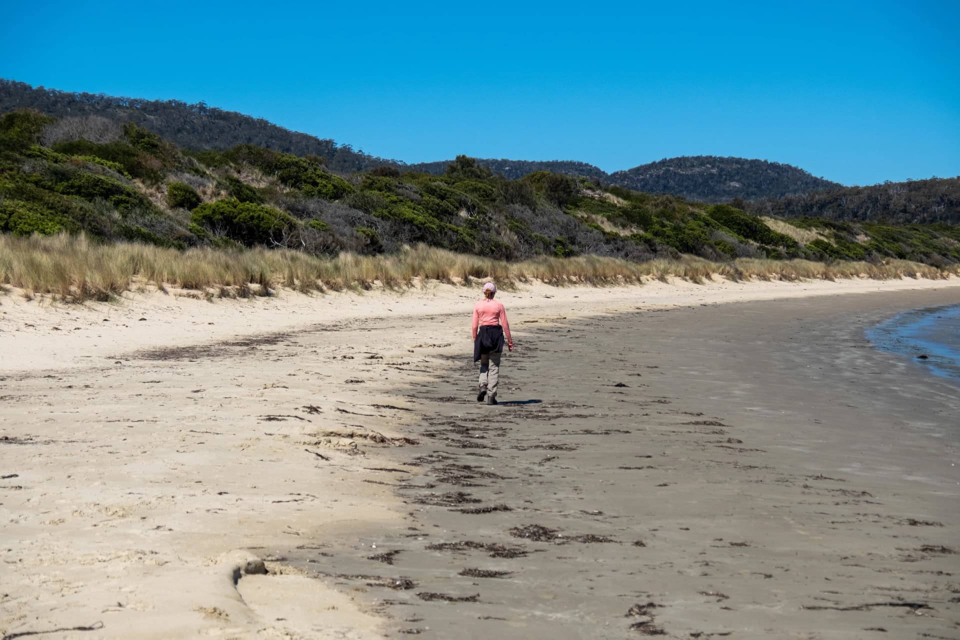 Walking a beach in Freycinet National Park