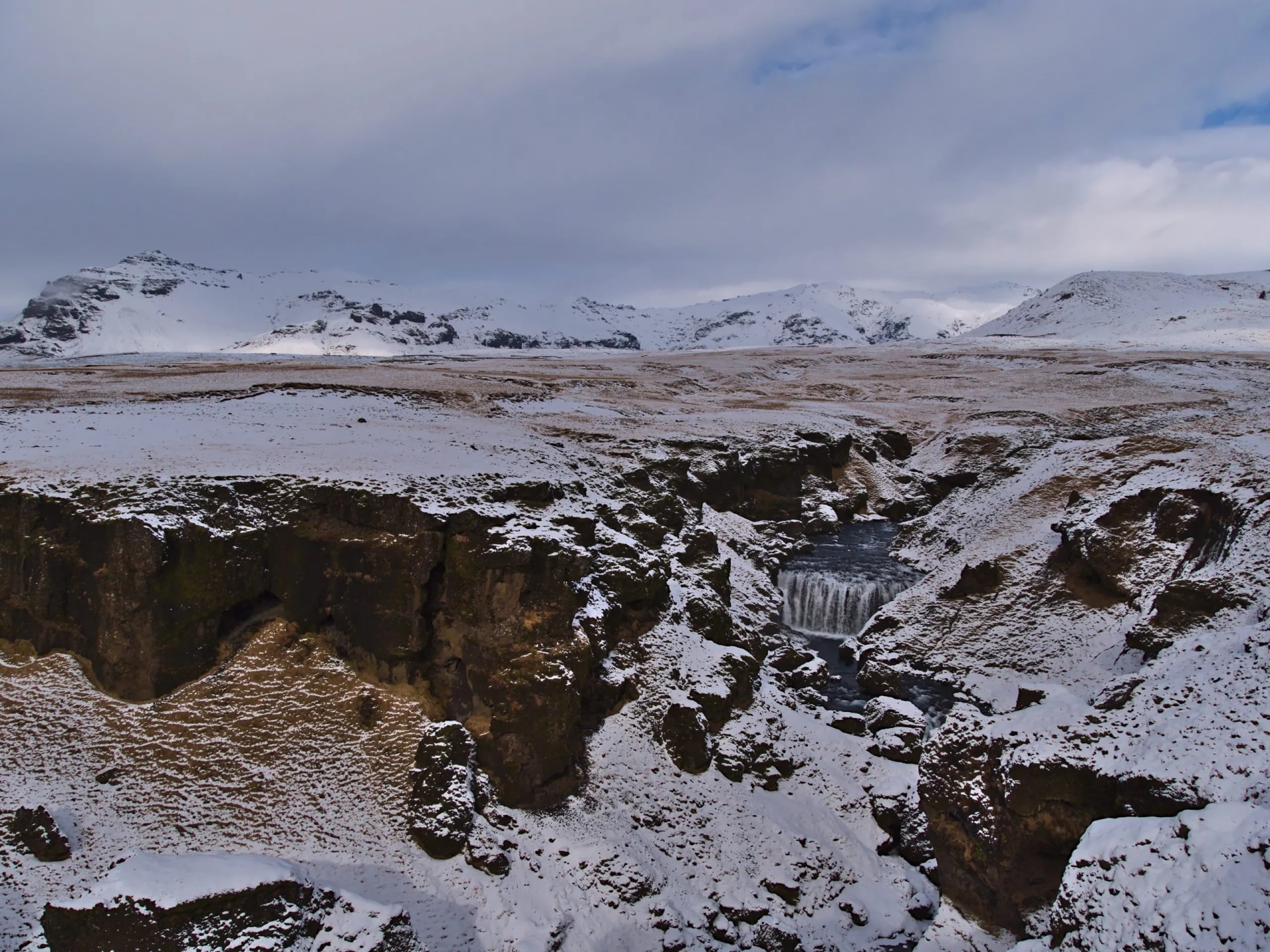 Steinbogafoss waterfall in a rocky canyon near Fimmvörðuháls trail in winter Iceland.