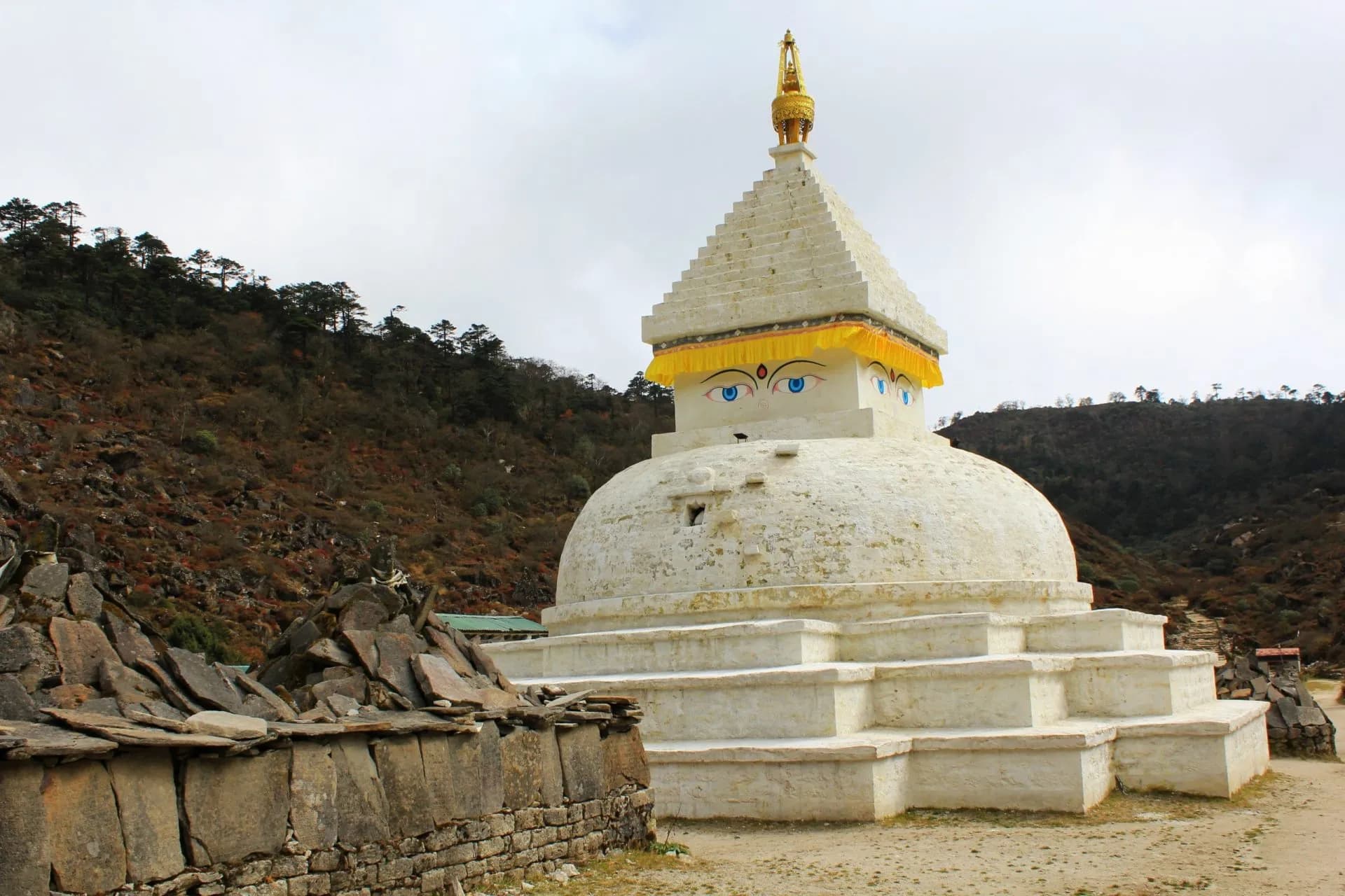 Tibetan buddhist stupa chorten shrine with Buddha eyes and colorful prayer flags near Khumjung Village, Namche Bazaar, Sagarmatha Khumbu Region, Nepal Himalaya